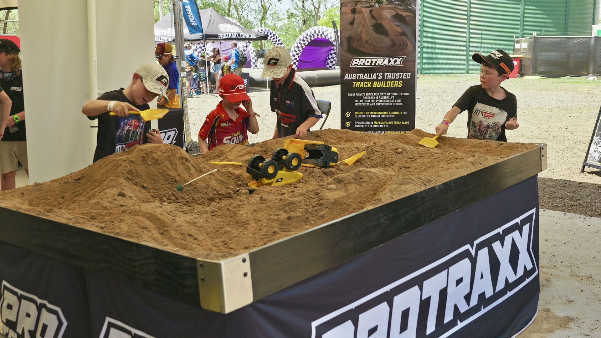 Kids playing in the Protraxx sandpit with Digger Kits at MXGP Darwin Kids playing in the Protraxx sandpit with Digger Kits at MXGP Darwin