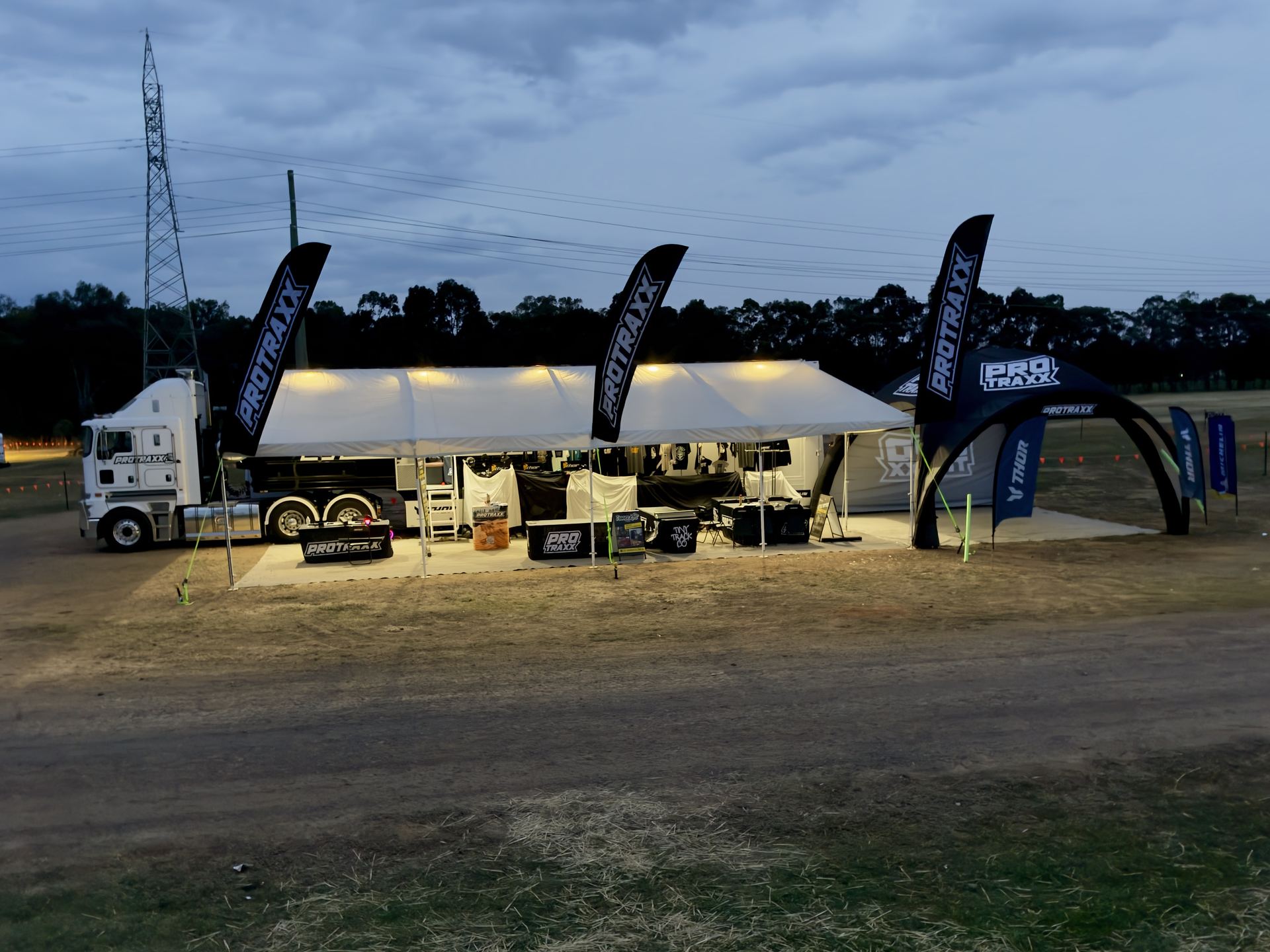 The Protraxx truck and shop lit up at dusk during AJMX 2026 in Shepparton